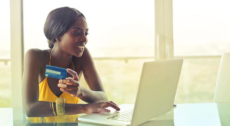 Everlytic | Blog | 5 Black Friday Online Marketing Ideas to Boost Your Revenue | African Lady Holding a Credit Card