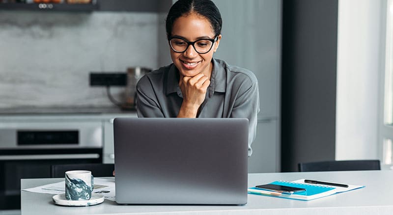 Everlytic | Blog | 4 Tips to Consider When Reviewing Your Email Sending Frequency | Woman Wearing Glasses Looking at a Laptop